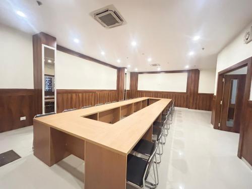a large room with a long table and chairs at Hotel Riddhi Inn in Udaipur