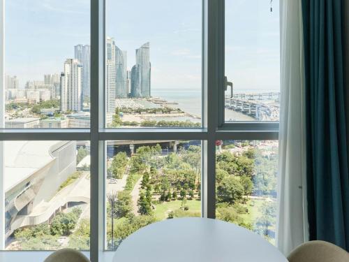 a view of a city from a window at NewCZ Centum Hotel in Busan