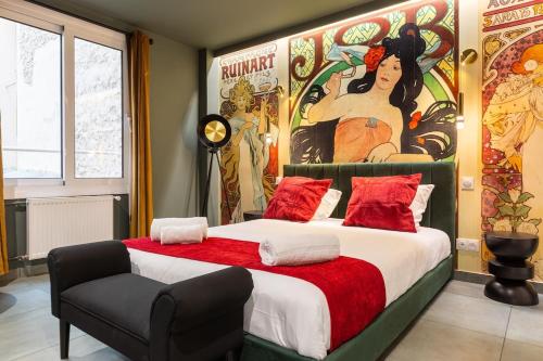 a bedroom with a large bed with a painting on the wall at Arc de Triomphe Romantic SUITE Jacuzzi Emeraude in Paris