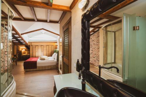a room with a bedroom with a bed and a bathroom at Raymar Hotels Ankara in Ankara