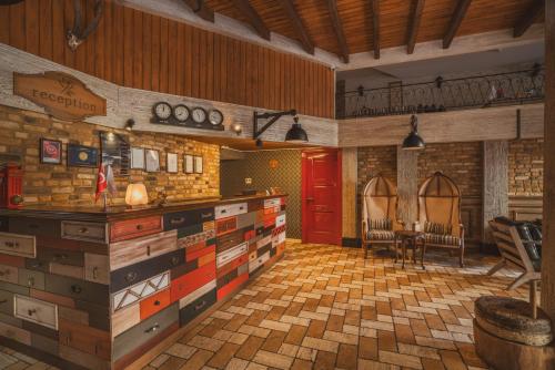 a kitchen with wooden cabinets and a red door at Raymar Hotels Ankara in Ankara