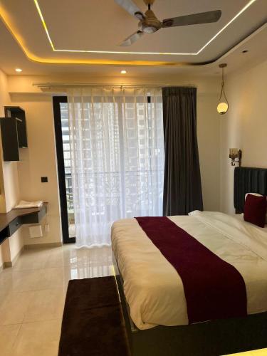 a bedroom with a large bed and a window at Leisure homes in Lucknow