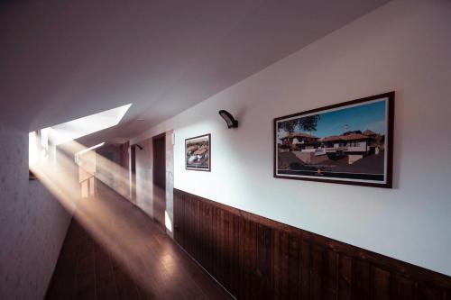 a hallway of a house with lights on the wall at Vinarija Djurdjevica Legat in Mionica