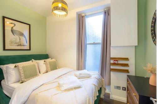 a bedroom with a large bed and a window at Sea Breeze - 1 bedroom flat in Brighton & Hove