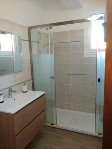 une salle de bain avec douche et lavabo dans l'établissement Centre ville avec vue magnifique sur le golfe d'Ajaccio; parking privé., à Ajaccio