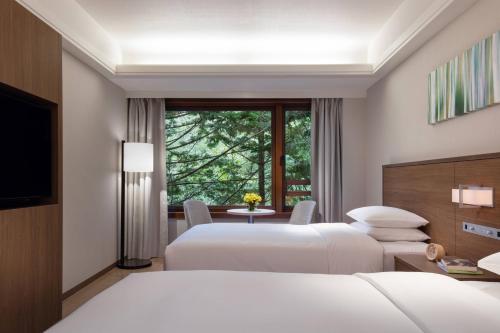 a hotel room with two beds and a window at Karuizawa Marriott Hotel in Karuizawa