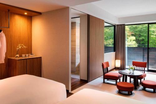 a bedroom with a bed and a table and chairs at Karuizawa Marriott Hotel in Karuizawa