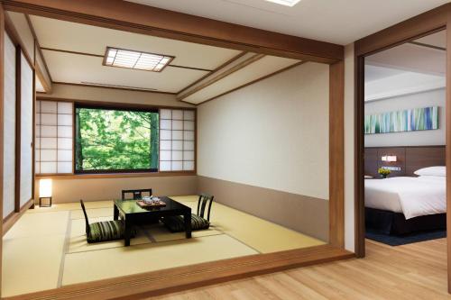 a room with a table and a bed at Karuizawa Marriott Hotel in Karuizawa