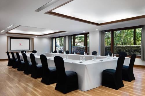 a conference room with a large white table and black chairs at Karuizawa Marriott Hotel in Karuizawa