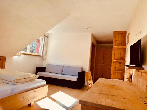 a living room with a couch and a table at Oberraut in Brunico