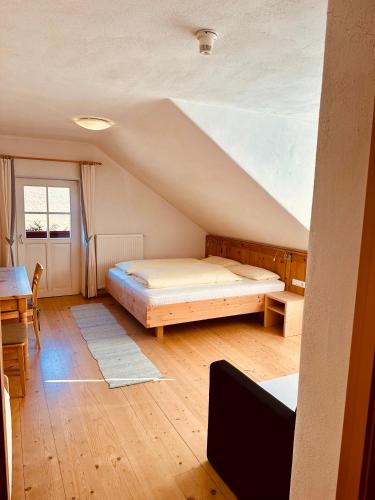 a bedroom with a bed and a table in a room at Oberraut in Brunico