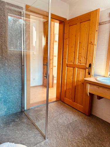 a bathroom with a shower and a glass door at Oberraut in Brunico