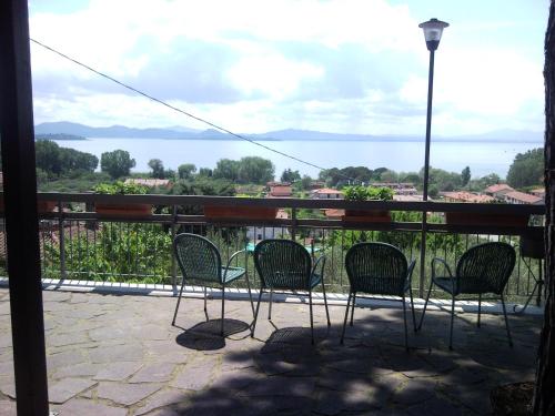 a balcony with chairs and a view of the water at Hotel Cavalieri in Passignano sul Trasimeno