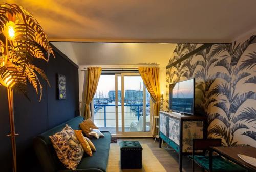 a living room with a couch and a television at The Marina retreat -free parking in Brighton & Hove