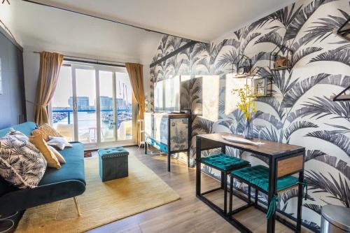 a living room with a blue couch and a table at The Marina retreat -free parking in Brighton & Hove