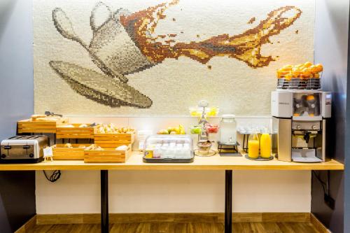 a table with food and drinks on it at Boutique Hostemplo Sagrada Familia in Barcelona
