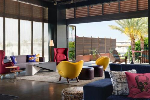 a lobby with colorful furniture and large windows at Aloft El Segundo - Los Angeles Airport in El Segundo