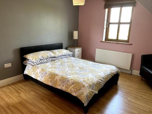 a bedroom with a bed and a window at House at the foot of The Galtees in Clohernagh
