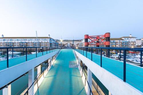 a walkway on a cruise ship with buildings in the background at Harbour Hideaway - Free Parking in Brighton & Hove