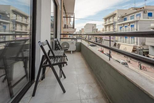 a balcony with chairs and a view of a city at Casa Anna Maria in Volos in Volos