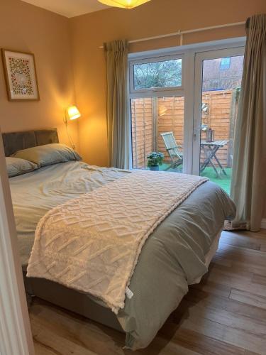 a bedroom with a bed and a sliding glass door at Lawson Lodge in Alveston