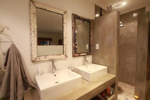 a bathroom with two sinks and two mirrors at Westbrook Beach Haven in Westbrook