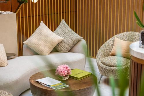 a living room with a couch and a coffee table at The Biltmore Hotel Villas, Dubai in Dubai
