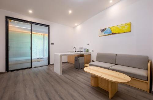 a living room with a couch and a table at Healing House--Free one way pick up service over 2 nights in Zhangjiajie