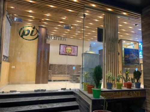 a lobby of a building with potted plants at LA Riqueza Pride Inn # Rootop Swimming Pool with Mountain View # Free Parking # Tapovan # Center of Rishikesh# in Rishīkesh