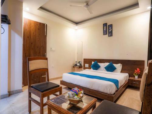 a bedroom with a large bed and a table at LA Riqueza Pride Inn # Rootop Swimming Pool with Mountain View # Free Parking # Tapovan # Center of Rishikesh# in Rishīkesh