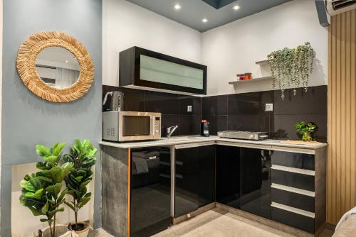 a kitchen with a counter with a microwave and a mirror at Royal Park Apartments Resort by Sea N Rent in Eilat