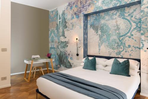 a bedroom with a large bed and a wall mural at Moon River Luxury Apartment in Rome