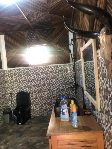 two bottles of cleaner sitting on top of a wooden table at STYLE MALGACHE et TOUT CONFORT in Nosy Be