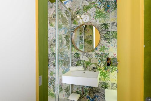 a bathroom with a sink and a mirror at Moon River Luxury Apartment in Rome