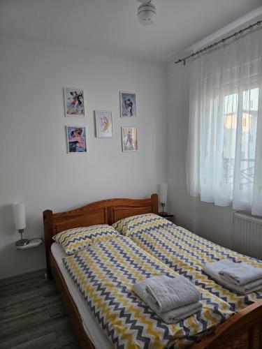 a bedroom with a bed with two towels on it at Apartman Sofija in Banja Koviljača