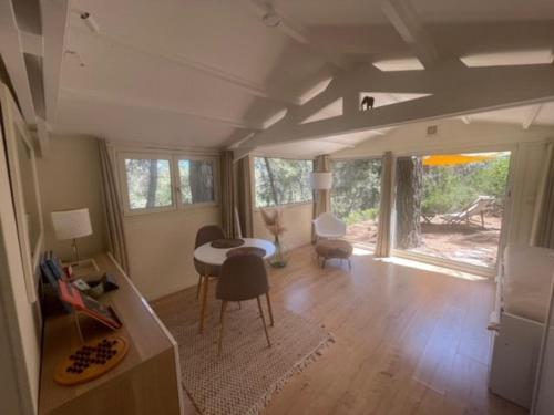 un salon avec une table et une salle à manger dans l'établissement Le Charmeur - Le Chalet Attrape-Coeur, à Aix-en-Provence