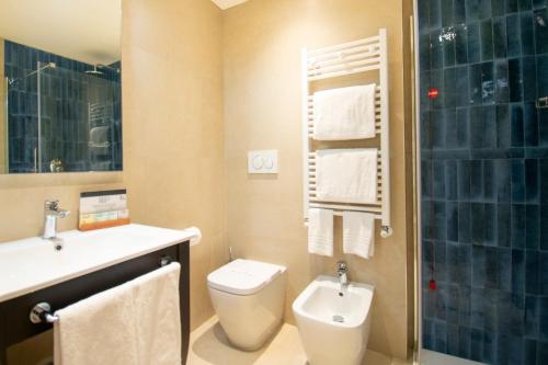 a bathroom with a toilet and a sink and a shower at Hotel Excelsior San Marco in Bergamo