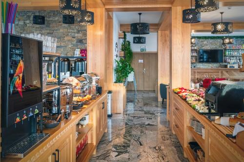 a restaurant with wooden counters and a bar at Malinowy Potok in Białka Tatrzanska