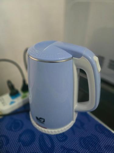 a blue coffee cup sitting on top of a table at Beautiful Studio 107 Apartment with nice living room with WiFi in Bangkok