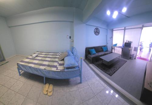 a bedroom with a bed and a couch in a room at Beautiful Studio 107 Apartment with nice living room with WiFi in Bangkok