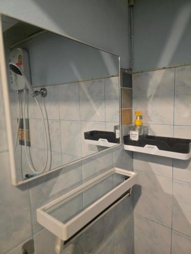 a bathroom with a shower and a mirror on the wall at Beautiful Studio 107 Apartment with nice living room with WiFi in Bangkok