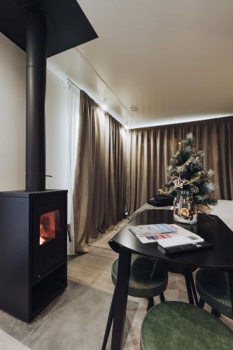 a living room with a fireplace and a christmas tree at ForRest Glamp Saulkrasti in Saulkrasti