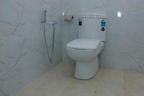 a bathroom with a toilet and a shower at Garden Villa in Midigama