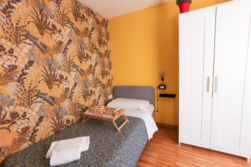 a small room with a bed and a wall at casa dolce casa in Rome