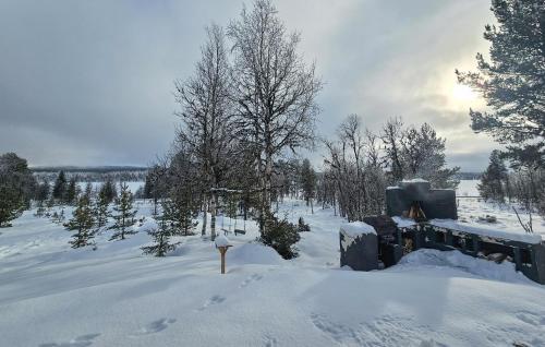 a snow covered field with trees and a sign in it at Stunning Home In Nesbyen With Wifi in Nesbyen