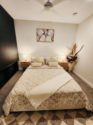 a bedroom with a large bed with two night stands at River & City View Apt near Brisbane Airport with Infinity Pool, Spa, Sauna, Steam Room in Brisbane
