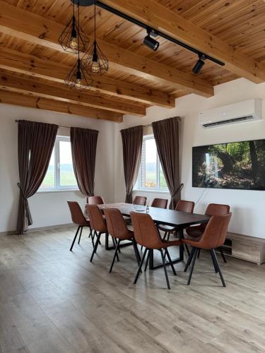 a dining room with a table and chairs at Sodyba Amberwood house in Petroškai