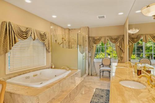 a large bathroom with a tub and a large window at @ Marbella Lane - Hidden Gem in Orange County in Orange