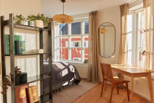 a bedroom with a bed and a desk and a table at Stunning 2 BR Home on Nyhavn with Private Balcony in Copenhagen