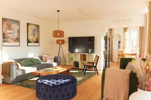 a living room with a couch and a table at Stunning 2 BR Home on Nyhavn with Private Balcony in Copenhagen